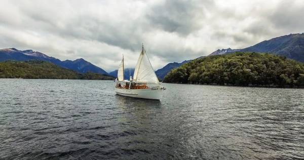 boat with sail up on Lake Te Anau, Fiordland, NZ